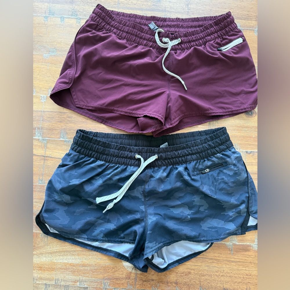 Two Vuori Women's Clementine Shorts - Black Camo and Burgundy